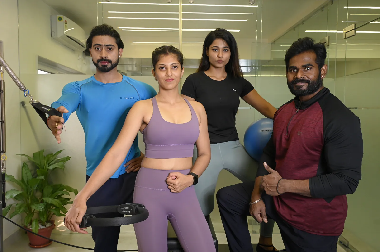 Group of people training together in Pilates studio